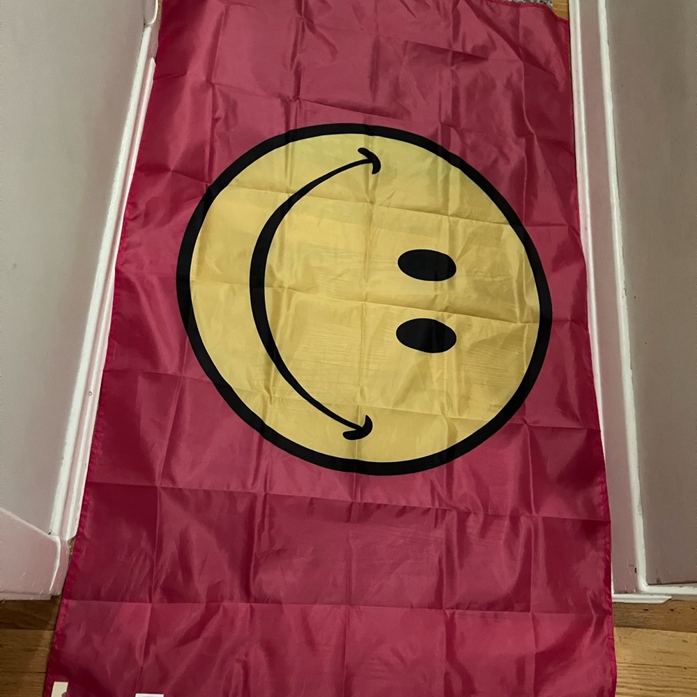 Huge smiley face with hot pink background flag